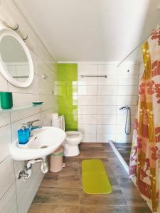 a bathroom with a sink and a toilet at Green Studio Nidri in Nydri