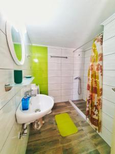 a bathroom with a white sink and a mirror at Green Studio Nidri in Nydri