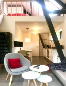 a living room with a chair and a red pillow at Haus Dohrmann in Binz