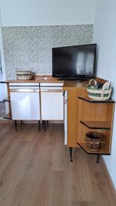 a wooden desk with a tv on top of it at Casa Lino in Premia