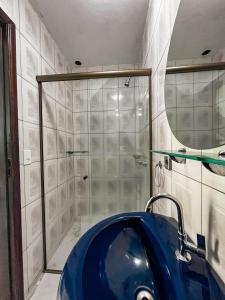 a bathroom with a shower and a blue tub at Hotel Garni Cruzeiro do Sul in Paraty