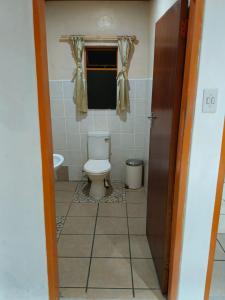 łazienka z toaletą i oknem w obiekcie Guest Lodge on the Edge w mieście Stormsrivier