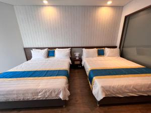 two beds in a small room with two at Apec Mandala Chambay Mũi Né in Ấp Thiẹn Ái +1 photo