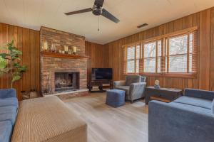 a living room with a couch and a fireplace at Silver Woods - New Vacation Rental - Lake Access Half a Mile away in Fennville