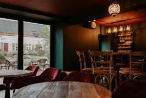 ein Restaurant mit Tischen und Stühlen und einem Fenster in der Unterkunft Walbrugge in Anzegem