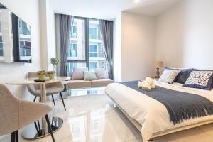 a bedroom with a bed and a living room at Hyde Sukhumvit 11 Branded Suites in Bangkok