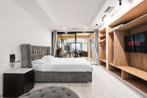 a hotel room with two beds and a tv at Puerto Banús Beach Apartments in Marbella +189 photos