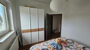 Office Escape - holiday home in Terme Čatež في برجيتسي: غرفة نوم مع سرير وخزانة بيضاء كبيرة