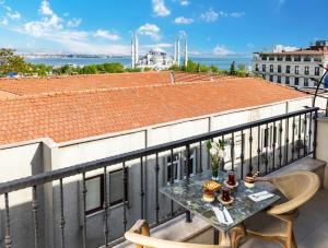 a balcony with a table and chairs on a roof at Rast Hotel Sultanahmet in Istanbul