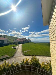 a view of a field with the sun in the sky at Habitaciones Hondar-Gain 10 in Zumaia