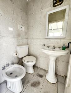 a white bathroom with a toilet and a sink at SanTelmo Casona Única 4Pisos Full Terraza Piscina Quincho Parrilla Ascensor 2Jacuzzis Sauna 7Dorm 6Baños in Buenos Aires +47 photos