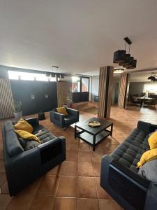 a living room with two couches and a table at Zajazd Restauracja Derby in Błonie +42 photos