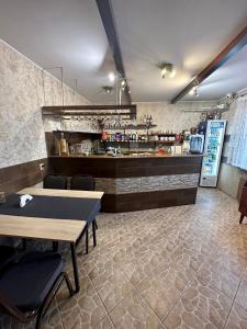 a restaurant with a counter and a table and chairs at Zajazd Restauracja Derby in Błonie