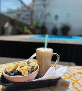 a bowl of cereal and a cup of coffee and a bowl of fruit at SanTelmo Casona Única 4Pisos Full Terraza Piscina Quincho Parrilla Ascensor 2Jacuzzis Sauna 7Dorm 6Baños in Buenos Aires