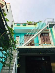 a blue building with stairs leading up to it at SEA HOME HOMESTAY in Ấp Bình Hưng