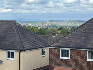 a view of roofs of houses in a city at 4-Bed Full House Stourbridge Birmingham in Stourbridge