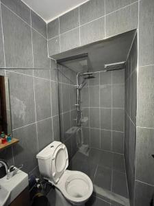 a bathroom with a white toilet and a shower at My HOMES APART EVLER in Akçatepe