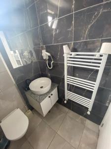 a small bathroom with a toilet and a sink at My HOMES APART EVLER in Akçatepe