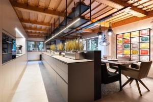 a kitchen with a long counter and a dining table at Tolles Ferienhaus in Wagrain Hofmark mit Offenerem Kamin in Wagrain