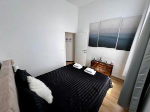 a bedroom with a black bed and a couch at Cozy South-Up in Brussels