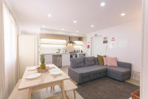a living room with a couch and a table at Best Houses 102 - Hut Spot Peniche in Peniche
