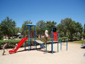 a playground in a park with people playing on it at Ningaloo Coral Bay – Bayview in Coral Bay