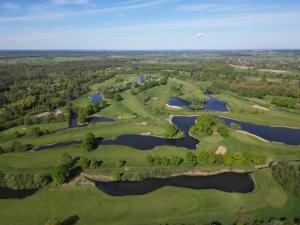 an overhead view of a golf course with several lakes at Schloss Lüdersburg Golf & Spa in Lüdersburg