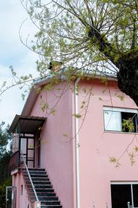 a pink building with stairs in front of it at AL Nonna Eli (Alojamento Local) in Campos