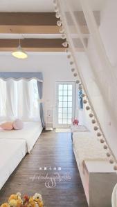 a bedroom with two beds and a stair case at Whitiedoggie Villa II in Checheng