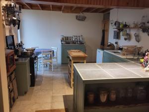 a kitchen with a counter and a table in it at Chez Marie Roulotte in Pontfarcy +28 photos