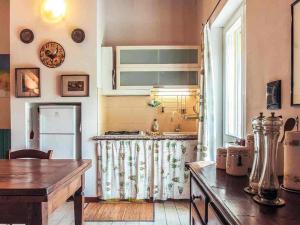 a kitchen with a table and a refrigerator at Relais Cascina San Martino in San Marzano Oliveto