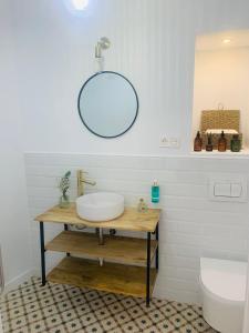 a bathroom with a sink and a mirror on the wall at Casa del Azucar in Motril