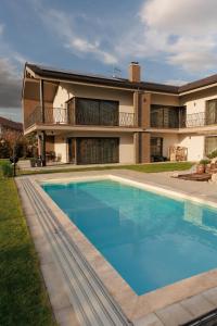 a large swimming pool in front of a house at Villa Panorama - Luxurious equipped modern spacious villa in Skalica
