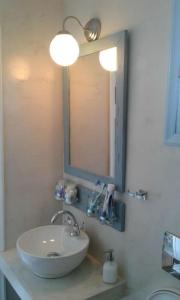 a bathroom with a sink and a mirror at Faro del mar in Naxos Chora +64 photos