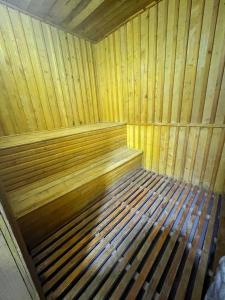 Una cama de madera en una sauna en una habitación en STS-Family home guest house, en Samarkand