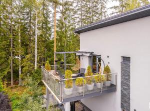 a balcony with potted plants on the side of a house at Villa David in Espoo