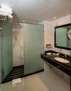 a bathroom with a shower and a sink and a mirror at Sierra Sharm El Sheikh in Sharm El Sheikh