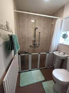 a bathroom with a shower and a toilet and a sink at Bungalow in Shildon County Durham in Shildon