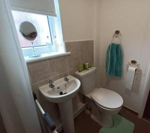 a small bathroom with a toilet and a sink at Bungalow in Shildon County Durham in Shildon