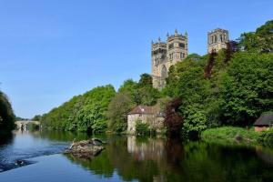 a castle sitting on top of a hill with a river at Bungalow in Shildon County Durham in Shildon