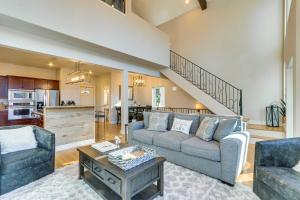 a living room with a couch and a table at Lakefront Coeur dAlene Home with Deck and Shared Dock in Coeur d'Alene