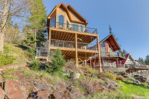 a large wooden house on top of a hill at Lakefront Coeur dAlene Home with Deck and Shared Dock in Coeur d'Alene