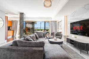 a living room with a couch and a table at Puerto Banús Beach Apartments in Marbella