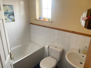 een badkamer met een toilet, een bad en een wastafel bij Superior 4 bedroom House Moville in Moville