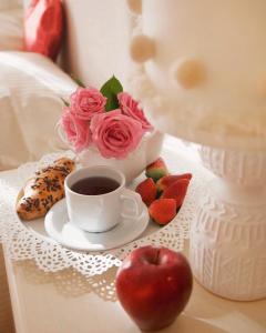 a tray with a cup of coffee and fruit on a table at Il Giardino di Cristina in Vagliagli