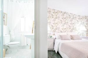 a white bedroom with a bed and a bathroom at Apartamento con Piscina Ribadumia in Ribadumia +27 photos