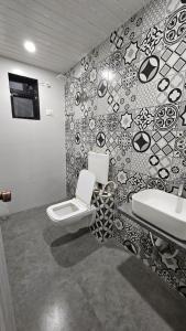 a bathroom with a toilet and a sink at Coastal Paradise in Alibaug