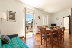 a living room with a table and chairs and a dining room at Appartamento Giade by BarbarHouse in Torre dell'Orso