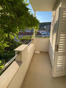 a balcony with stairs and a view of the water at apartmani Isabella - Ilda Radonic in Jelsa