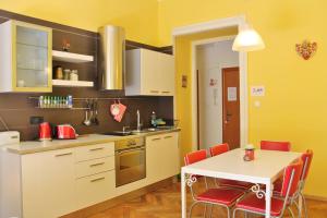 a kitchen with a table and a table and chairs at Apartment Colors of Life in Rijeka